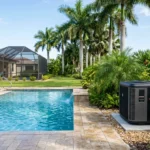 A modern pool heat pump unit installed in a tropical Brevard County backyard next to a clear blue swimming pool.